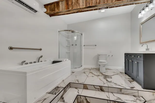 a bathroom with a sink a toilet and shower