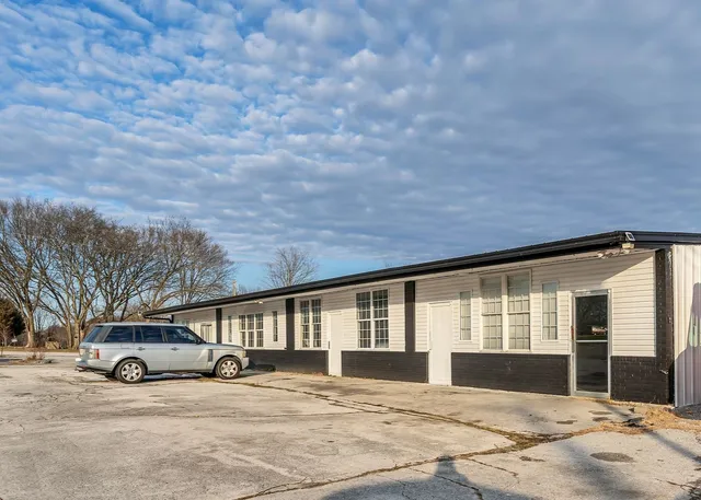 a view of a house with a yard and garage