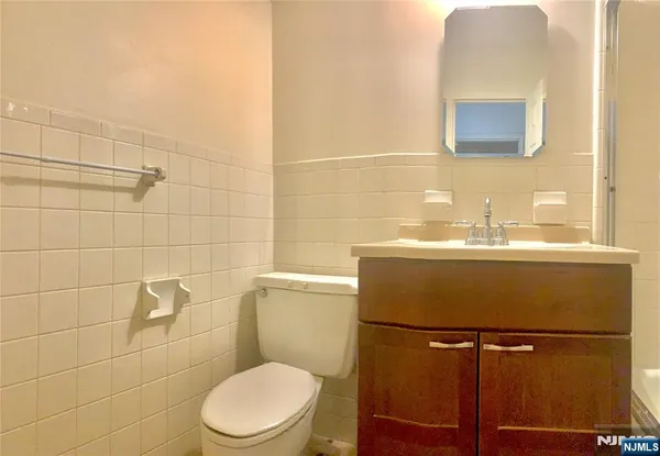 a white toilet sitting next to a bathroom sink