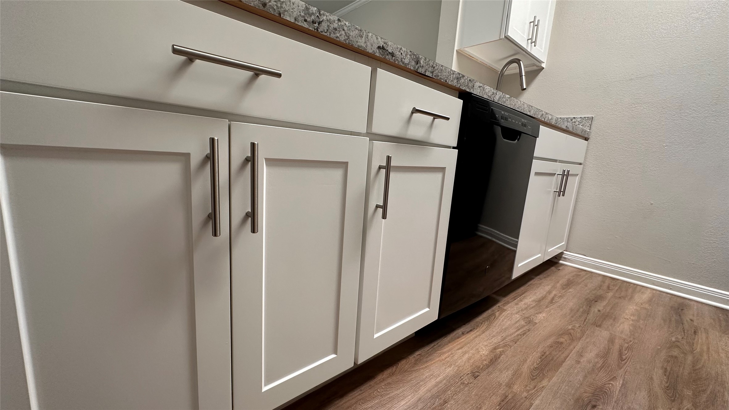 7315 Brompton Street, Unit 127B Houston, TX 77025 - Photo 13 of 13 a view of a hallway with wooden floor