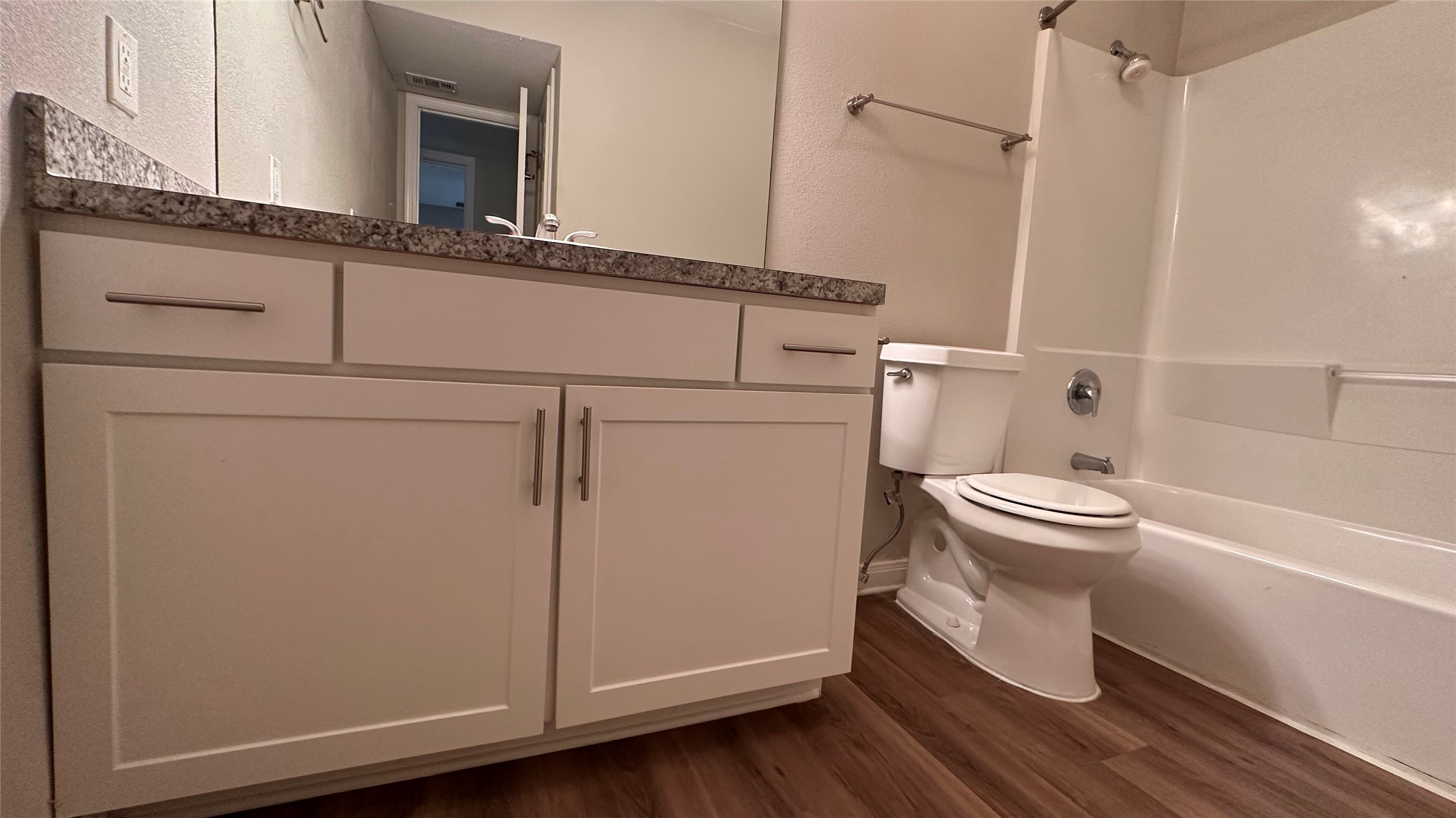 7315 Brompton Street, Unit 127B Houston, TX 77025 - Photo 2 of 13 a bathroom with a toilet and a shower