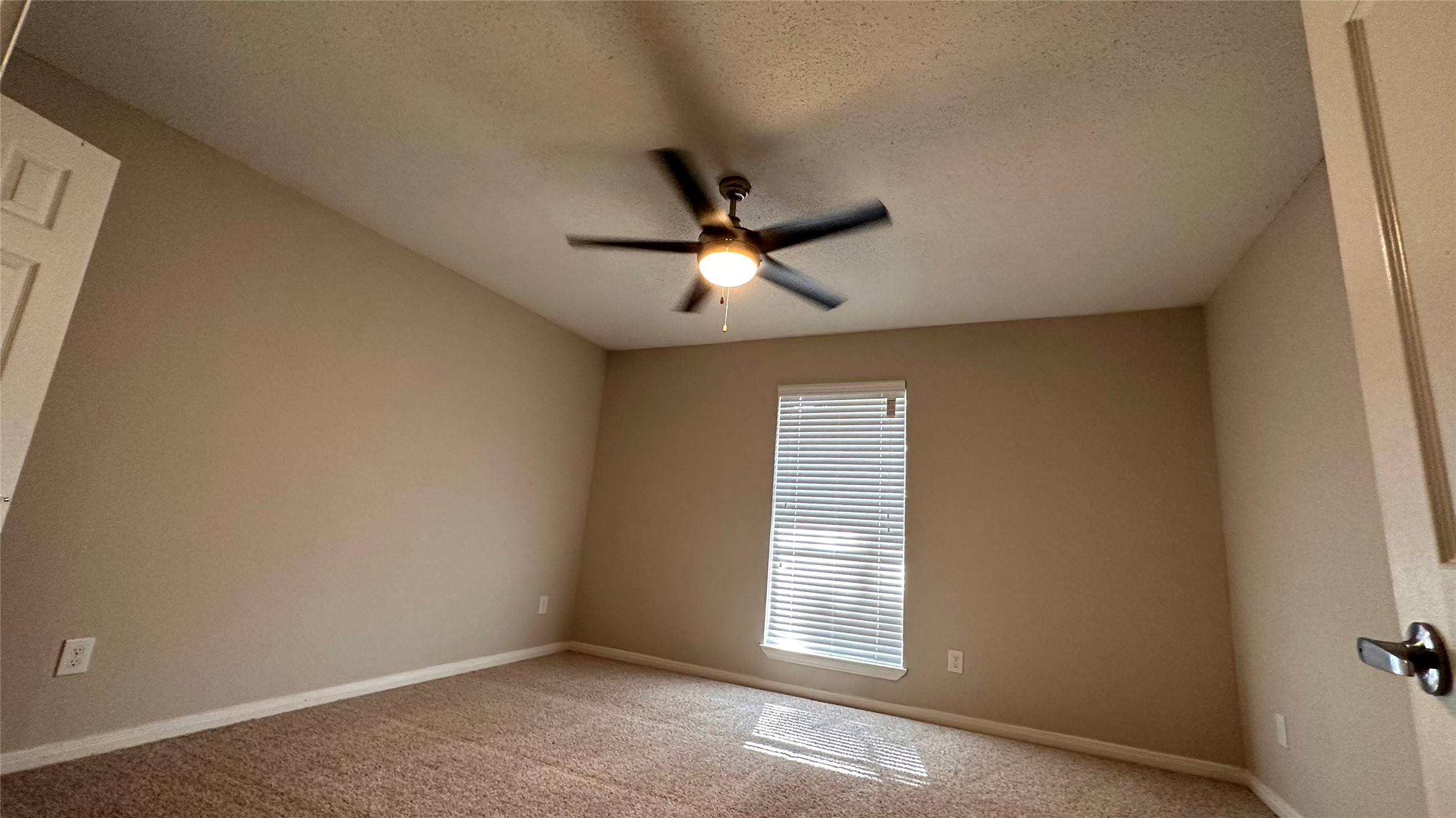 7315 Brompton Street, Unit 127B Houston, TX 77025 - Photo 4 of 13 an empty room with window and ceiling fan