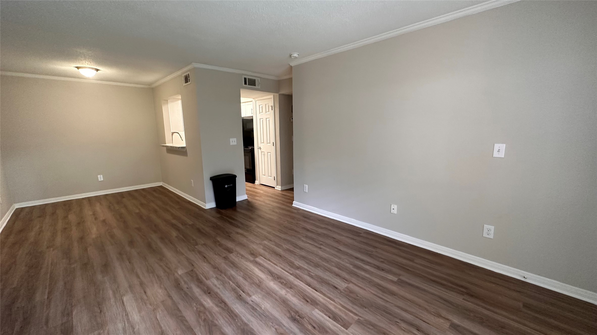 7315 Brompton Street, Unit 127B Houston, TX 77025 - Photo 7 of 13 a view of an empty room with wooden floor and a window