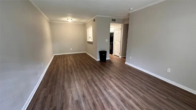 a view of a room with wooden floor