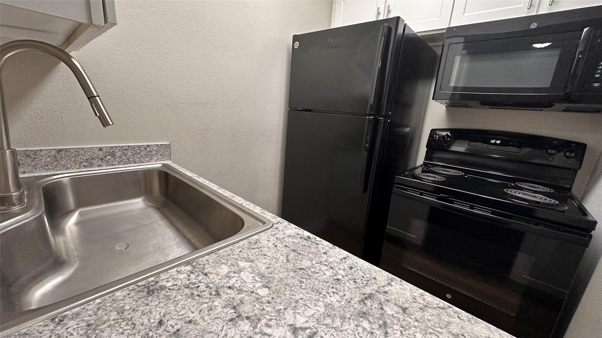 7315 Brompton Street, Unit 127B Houston, TX 77025 - Photo 10 of 13 a kitchen with a refrigerator and a sink