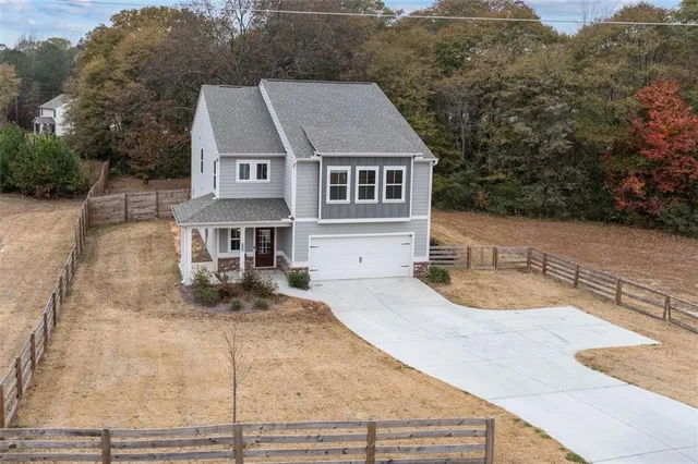 an aerial view of a house with yard