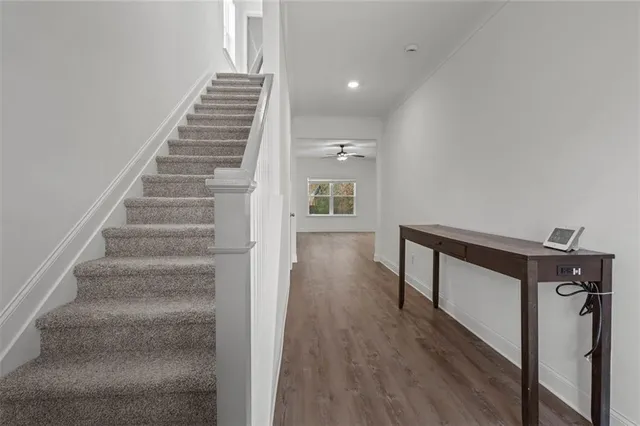 a view of entryway and hall with wooden floor