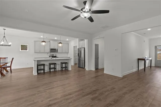 a view of a kitchen with dining room and wooden floor