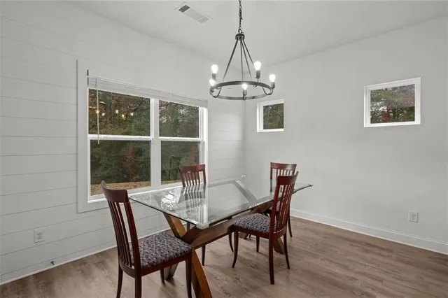 a view of a dining room with furniture window and wooden floor