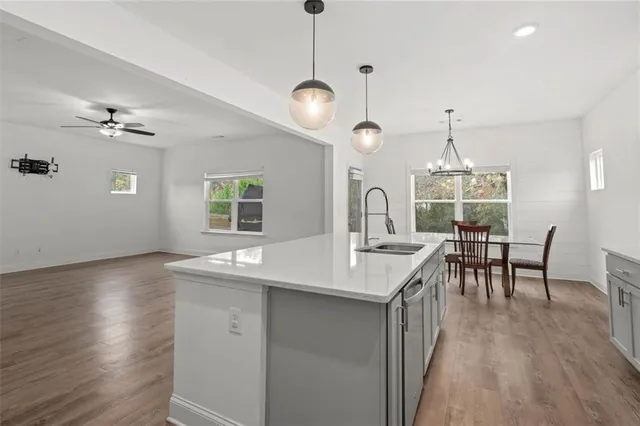a kitchen with center island table and chairs