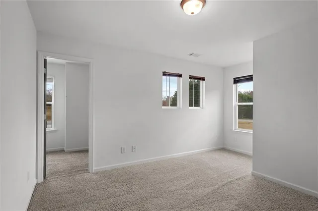 an empty room with windows and closet