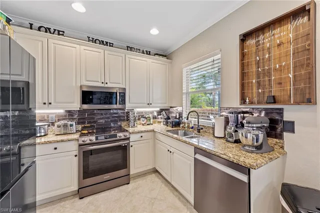a kitchen with stainless steel appliances granite countertop a sink stove and microwave
