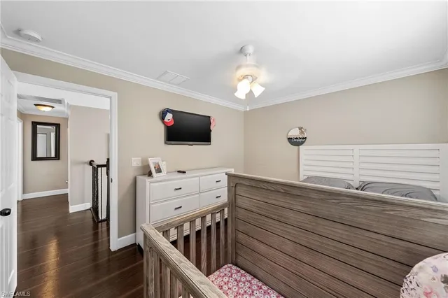 a view of a hallway with workspace and wooden floor