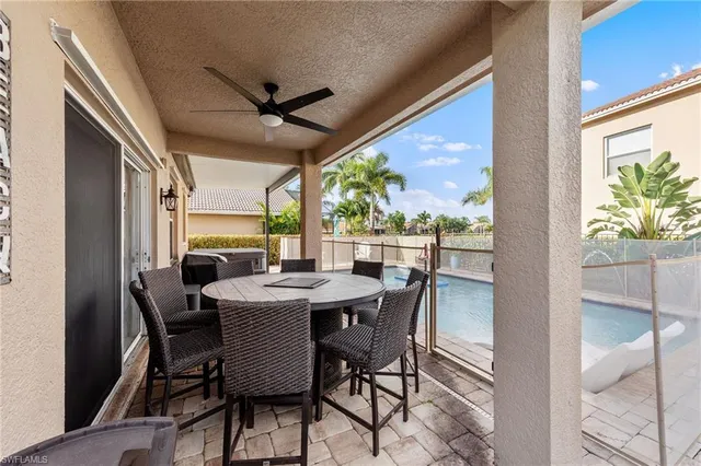 a view of a swimming pool and outdoor seating