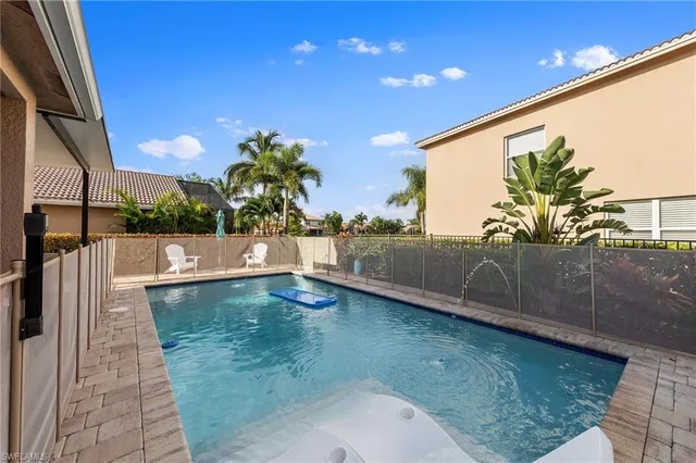 a view of a house with backyard and sitting area