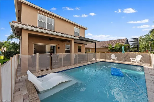 a view of a house with a yard and potted plants