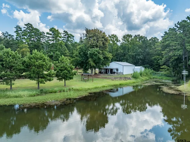 a view of a lake with a house in the background