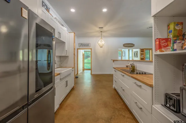 a large kitchen with cabinets and stainless steel appliances