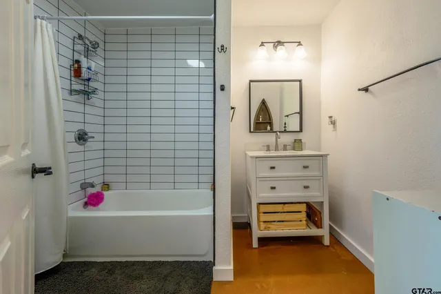 a bathroom with a bathtub and a shower