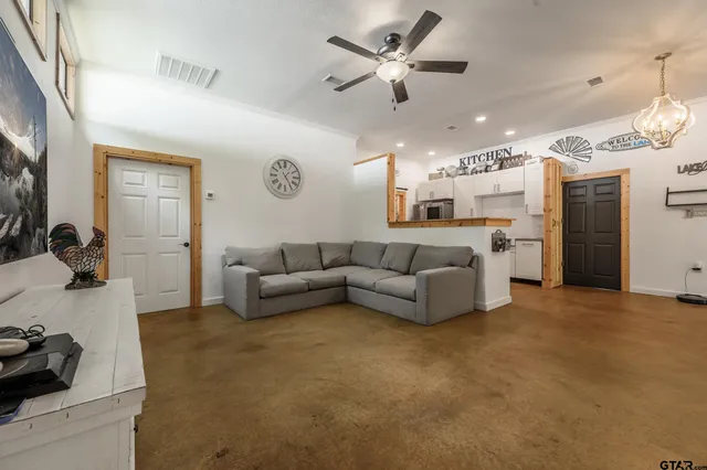 a living room with furniture and kitchen view