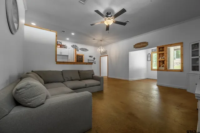 a living room with furniture and a chandelier