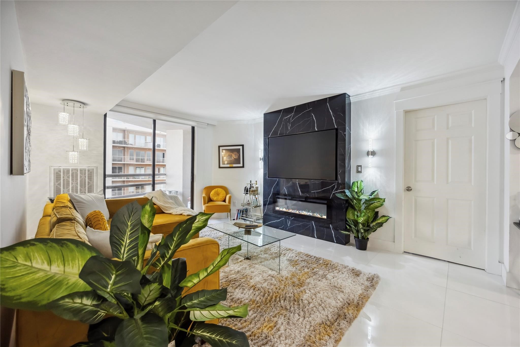3525 Sage Road, Unit 1713 Houston, TX 77056 - Photo 5 of 25 a living room with furniture flowers and a flat screen tv