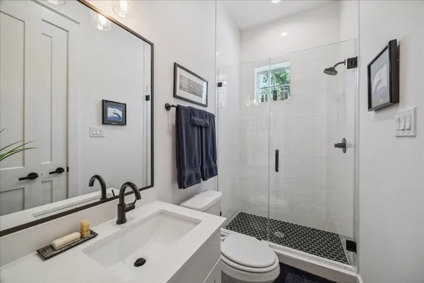 a bathroom with a sink toilet and shower