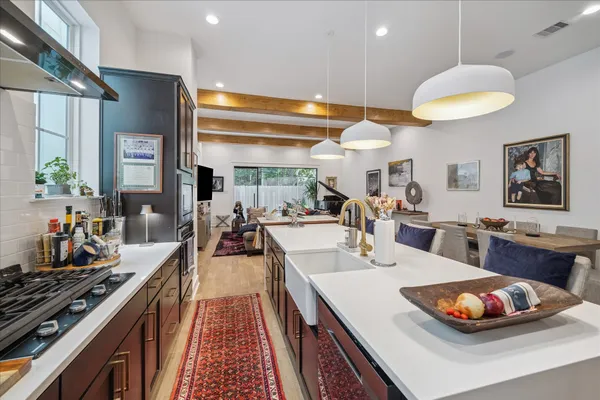 a large kitchen with a table and chairs