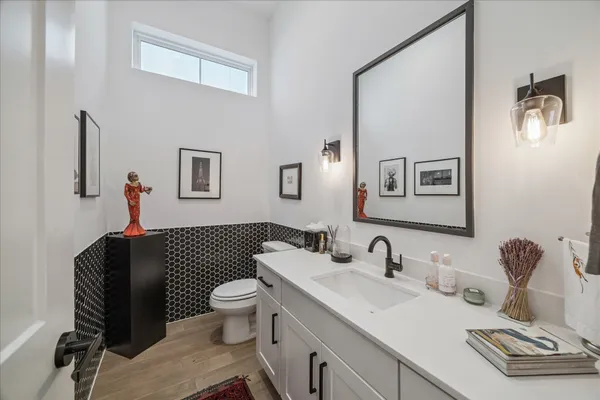a bathroom with a sink toilet and a mirror