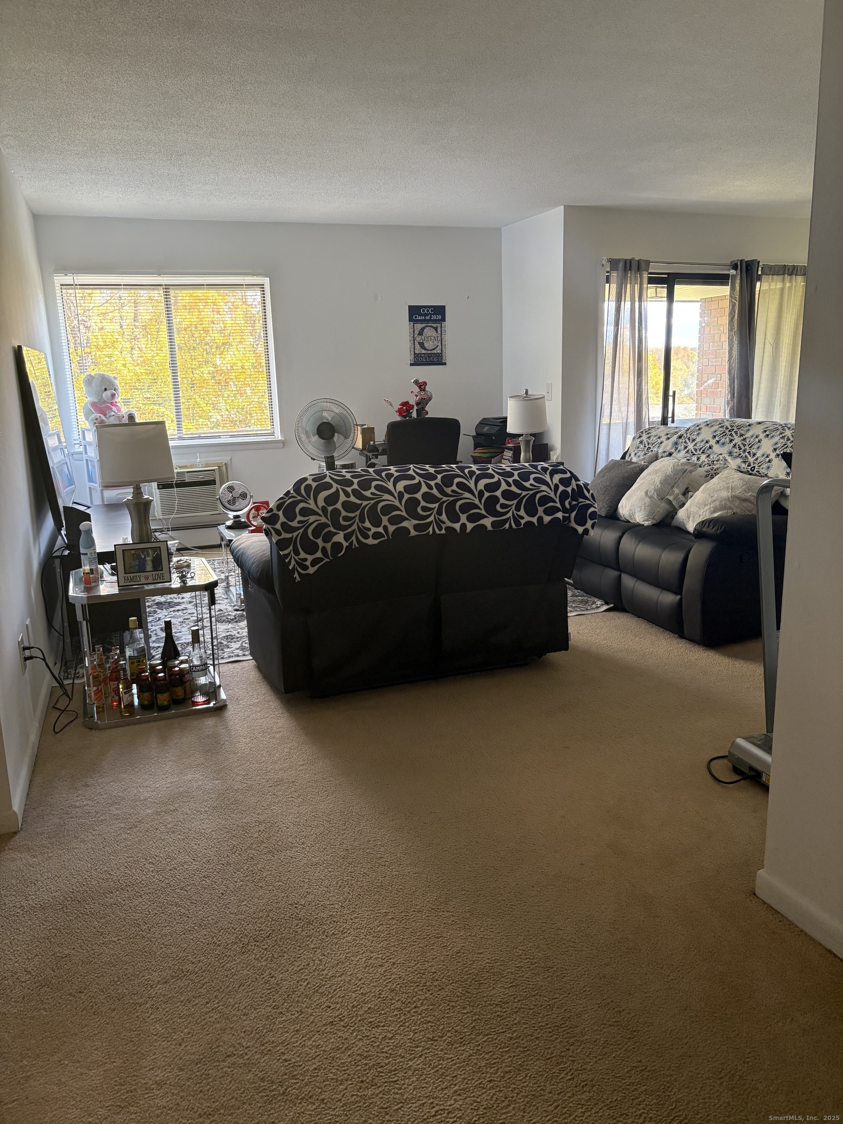 962 High Path Road, Unit 962 Windsor, CT 06095 - Photo 2 of 14 a bed room with a bed and a chair