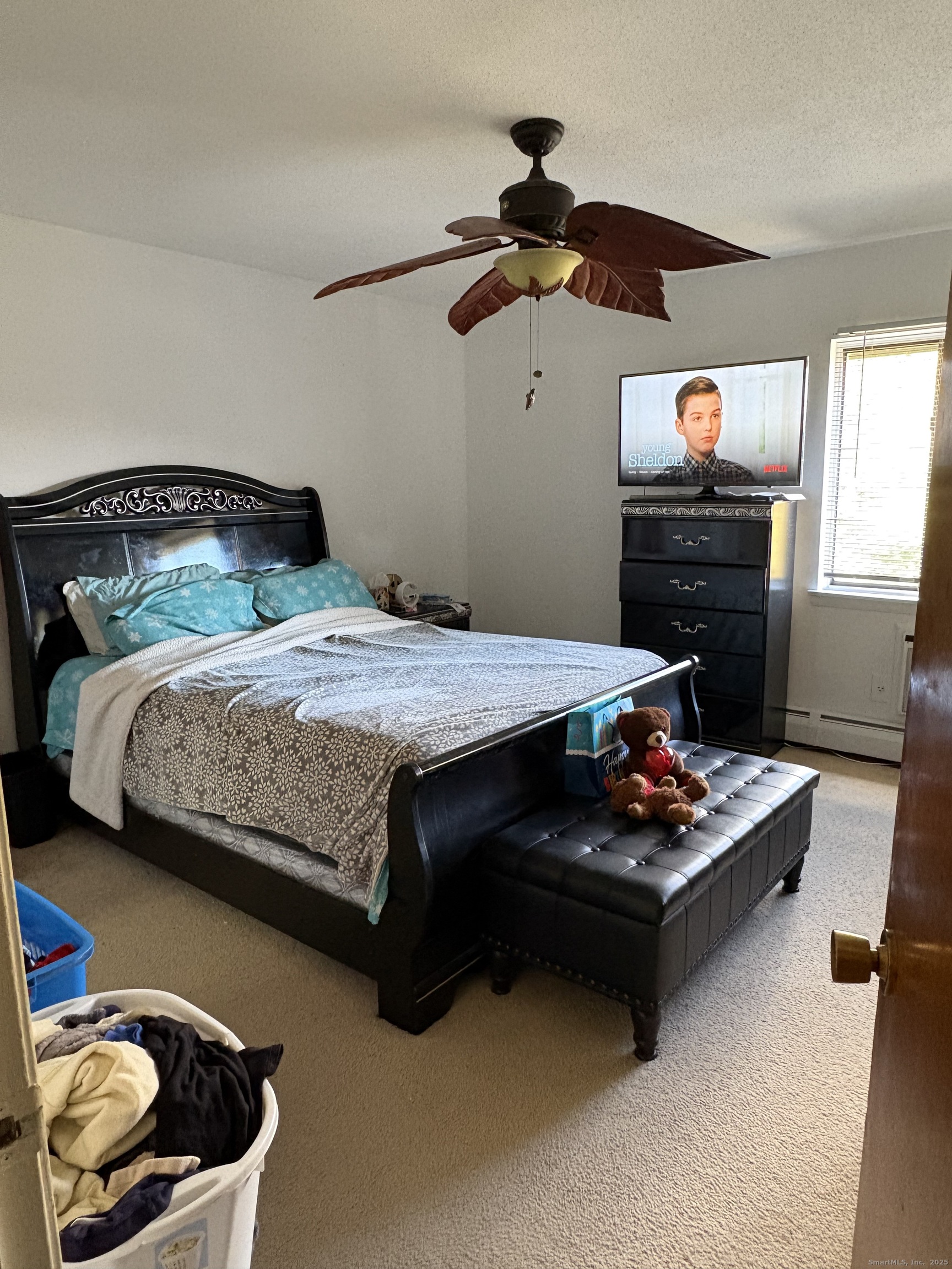 962 High Path Road, Unit 962 Windsor, CT 06095 - Photo 8 of 14 a bedroom with a bed and a chandelier