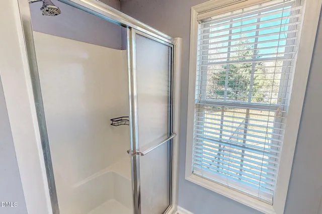 a bathroom with a glass shower door