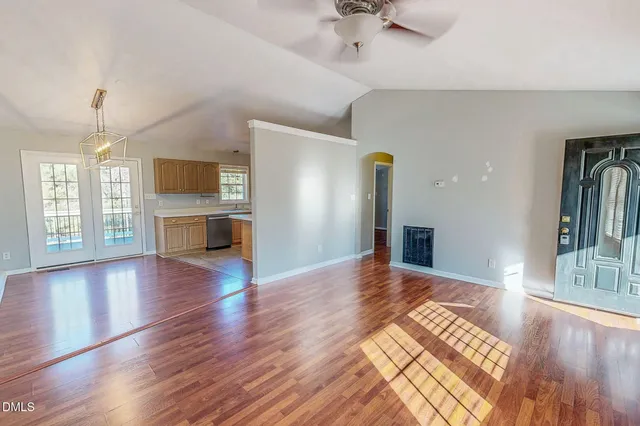 a view of empty room with wooden floor and fireplace