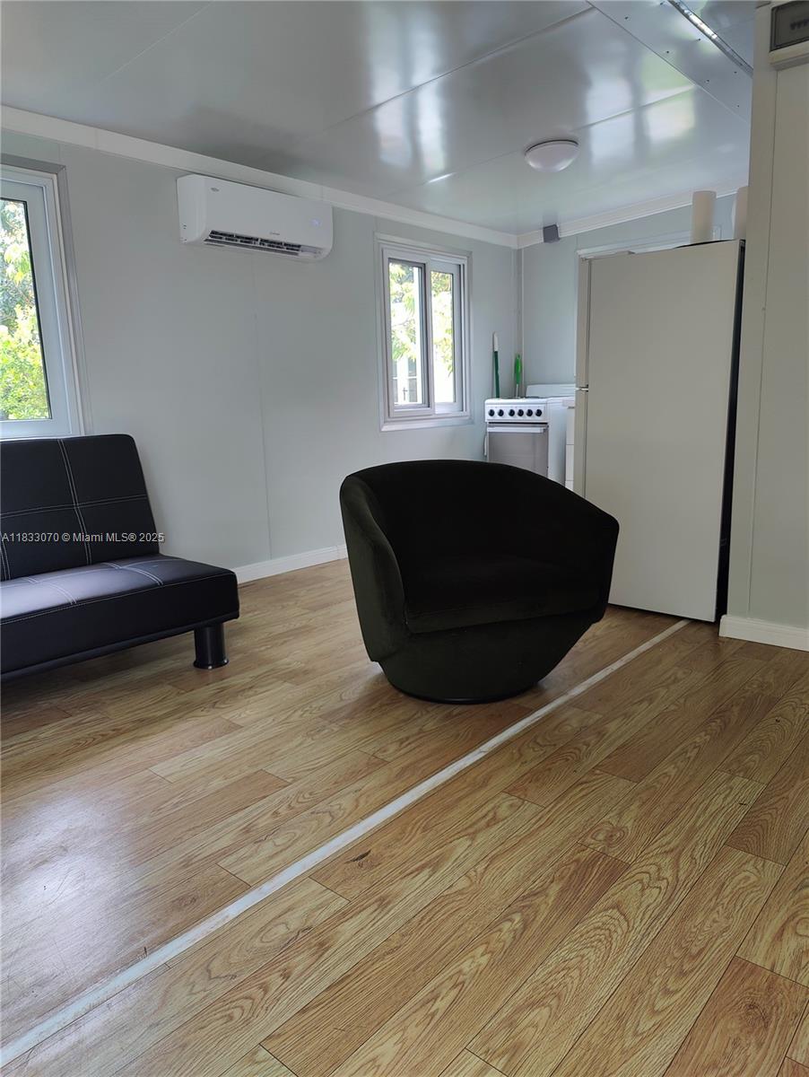 16475 Southwest 248th Street, Unit C Homestead, FL 33031 - Photo 6 of 6 a living room with furniture and a wooden floor