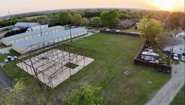 an aerial view of a house with a yard table and chairs