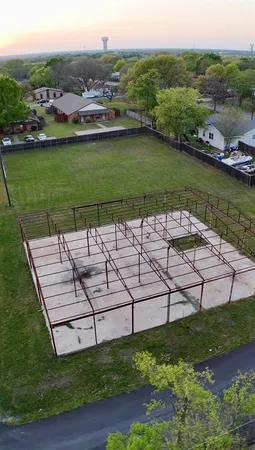 an aerial view of a house with a garden and lake view