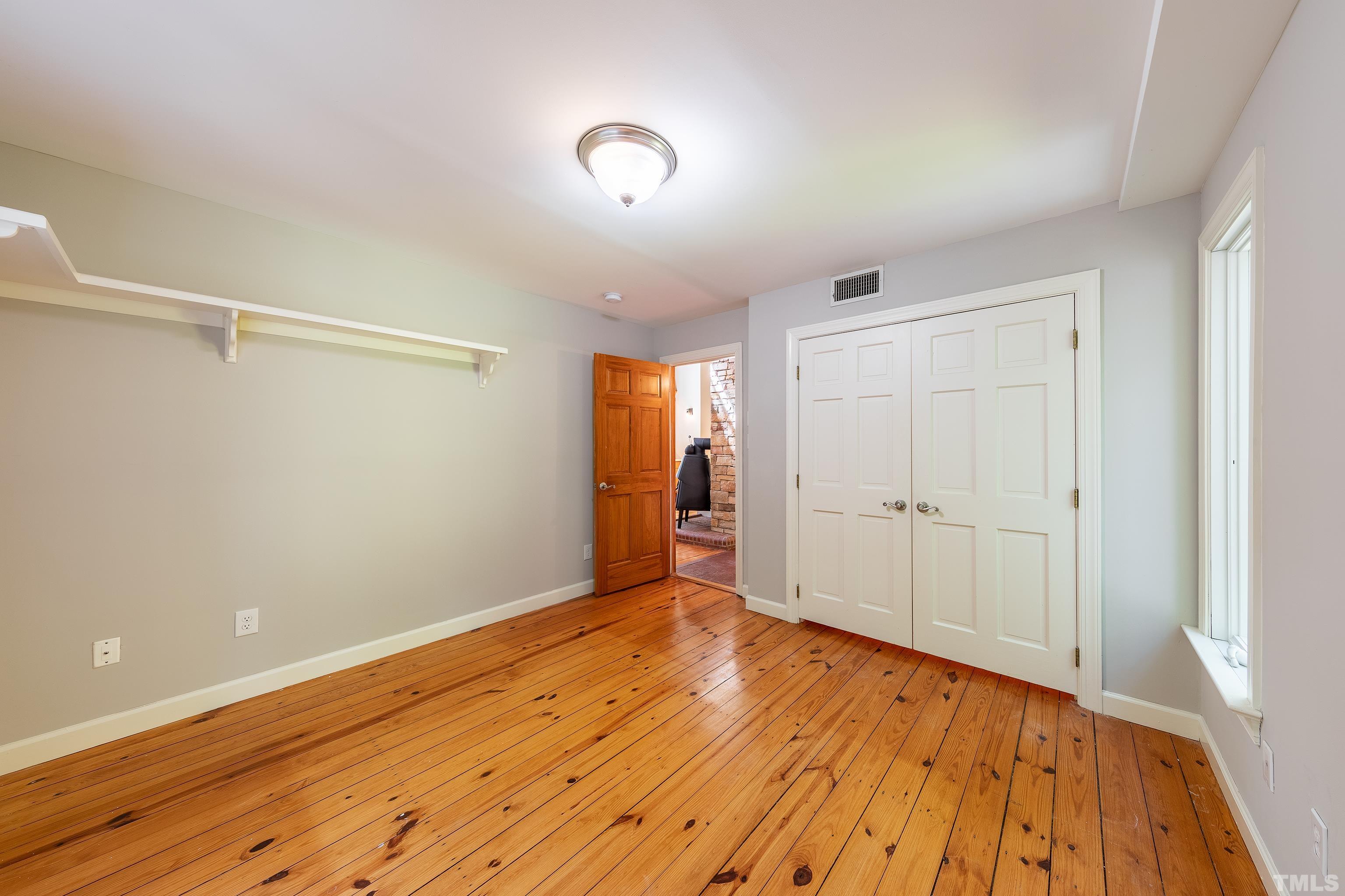 12217 Old Creedmoor Road Raleigh, NC 27613 - Photo 20 of 41 a view of empty room with wooden floor