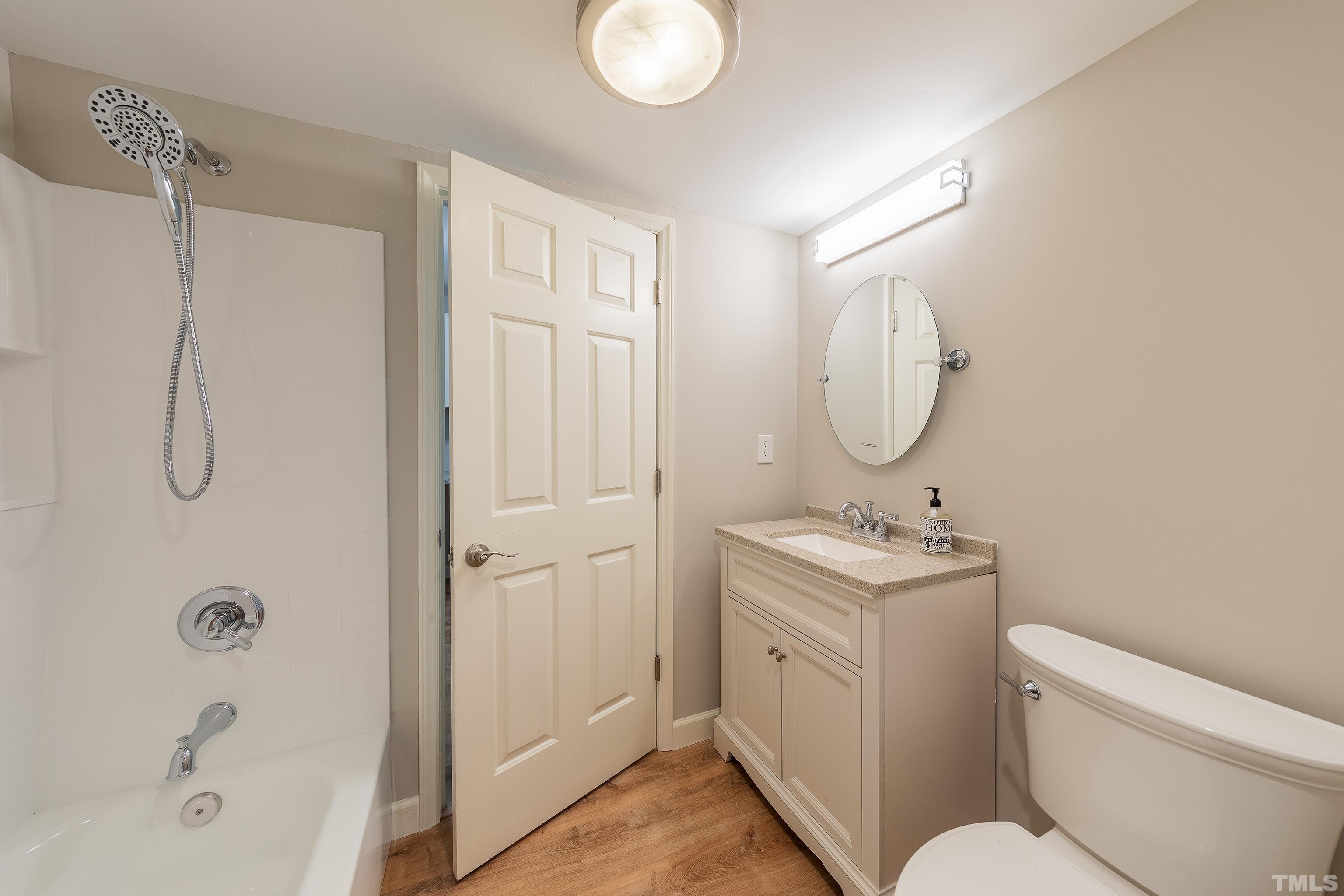 12217 Old Creedmoor Road Raleigh, NC 27613 - Photo 23 of 41 a bathroom with a granite countertop sink toilet and shower