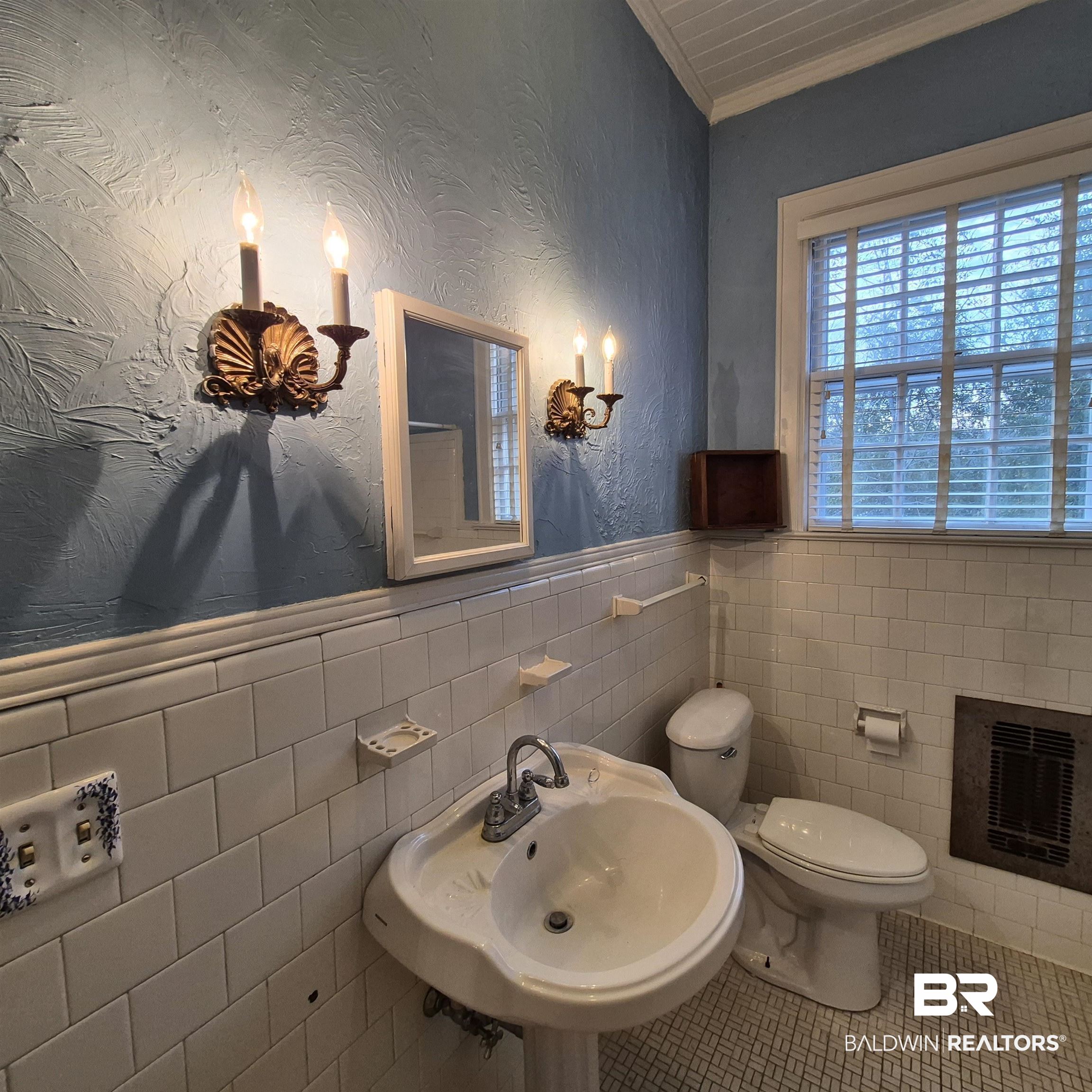 308 Rural Street Evergreen, AL 36401 - Photo 12 of 40 Half bath with a wainscoted wall, ornamental molding, a textured wall, tile walls, and heating unit