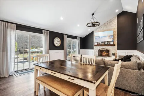 a kitchen with a table chairs and a large window