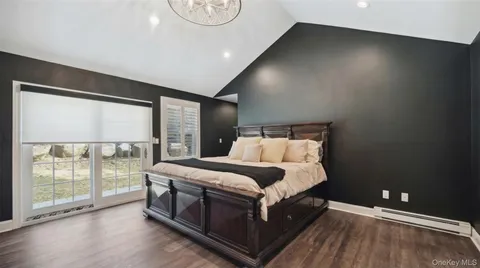 a bed room with a bed and a large window