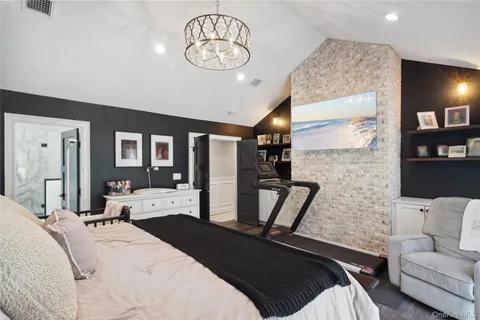 a bedroom with a bed and walk in closet