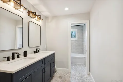 a bathroom with a double vanity sink mirror and