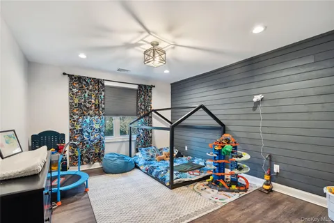 a view of a patio with couches table and chairs under an umbrella