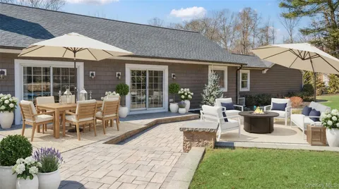 a front view of a house with a yard and trees