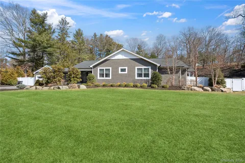 a front view of a house with a yard table and chairs