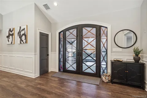 a view of an entryway with wooden floor