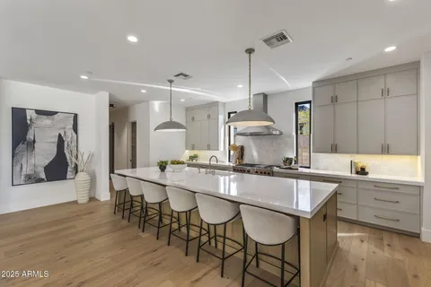 a large kitchen with a table and chairs in it