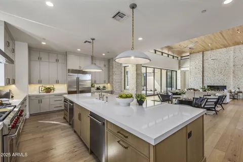 a kitchen with sink stove and chairs