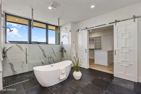 a bathroom with a bathtub and shower